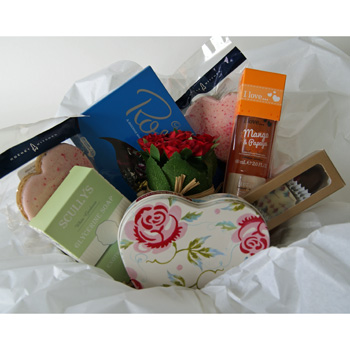 Great assortment of gifts in this Cake Tin flowers delivery - Flowers Auckland